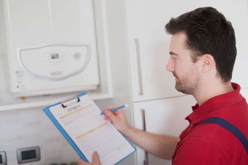 hvac-technician-checking-a-hot-water-heater-maintenance-checklist